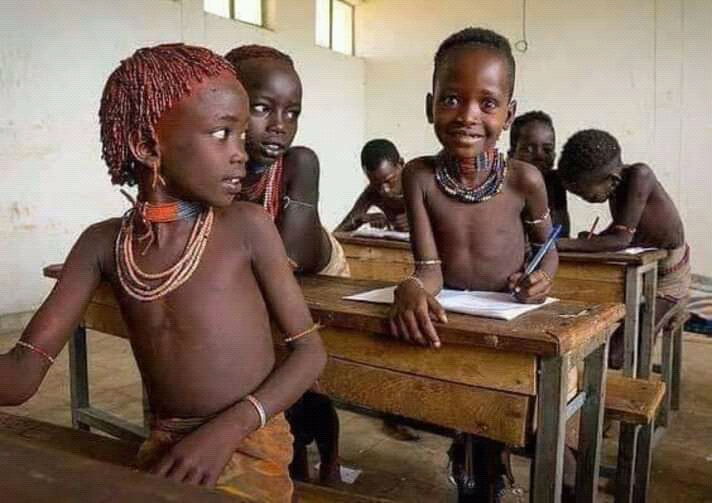 ""Kenyan Samburu children in a classroom," by Moses Mwombe, under CC 4.0 license at https://commons.wikimedia.org/wiki/File:Kenyan_Samburu_children_in_a_classroom.jpg